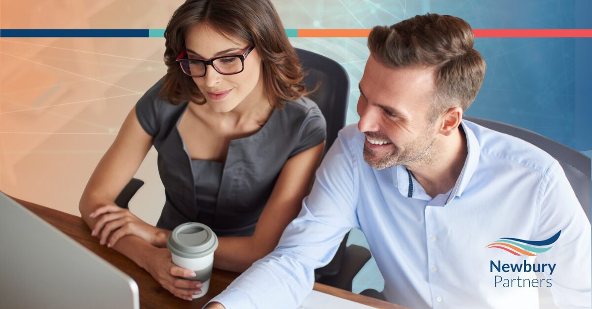 Two colleagues analyzing CRM data as part of a Bullhorn data health check.