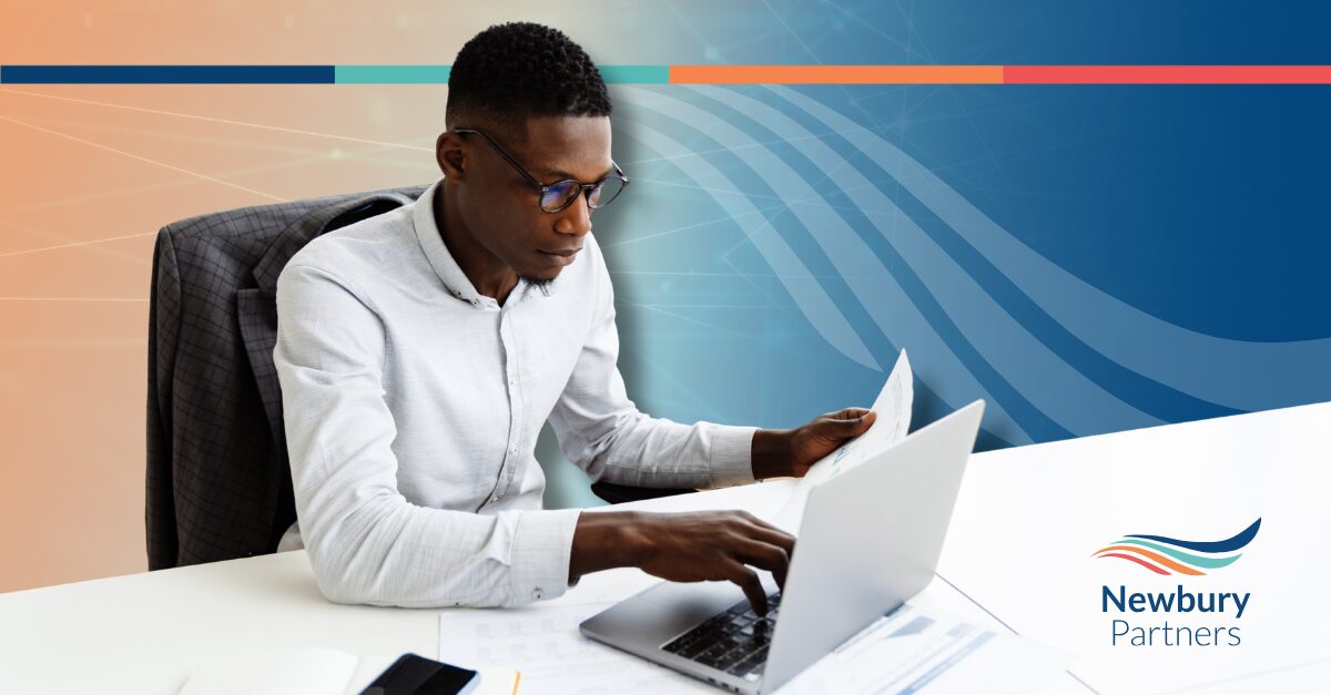Professional reviewing reports on a laptop to evaluate Bullhorn admin cost.